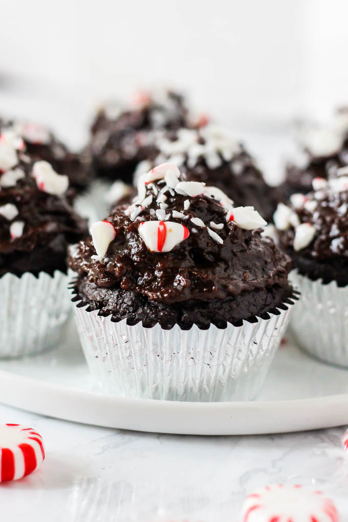 a plate of chocolate peppermint cupcakes in silver foil liners