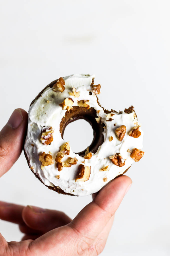 a hand holding a vegan gingerbread donut