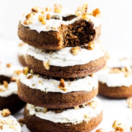 a stack of gingerbread donuts topped with chopped pecans