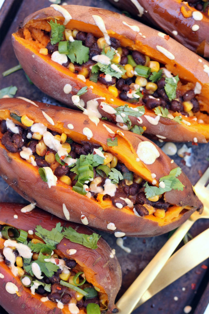 a tray of black bean stuffed sweet potatoes