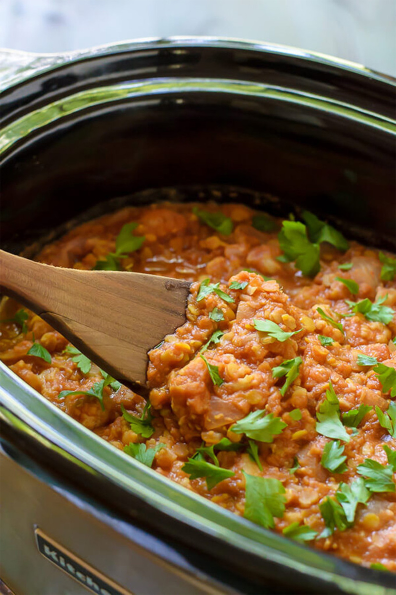 a slow cooker filled with red lentil curry