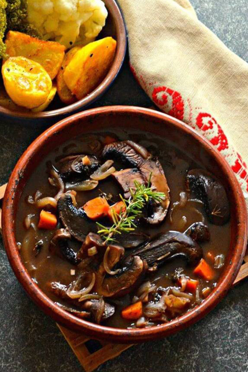 a portobello mushroom pot roast served in a red bowl