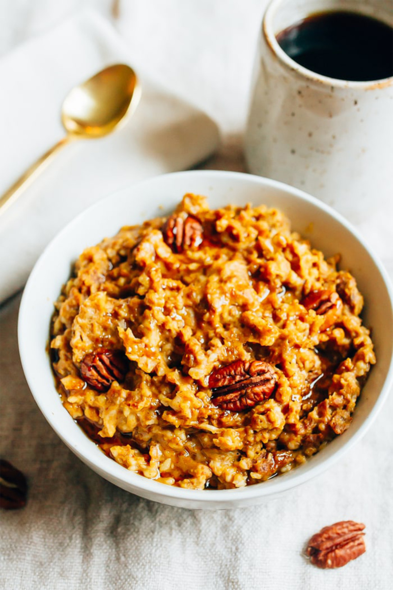 a bowl of pumpkin pie oatmeal topped with pecans