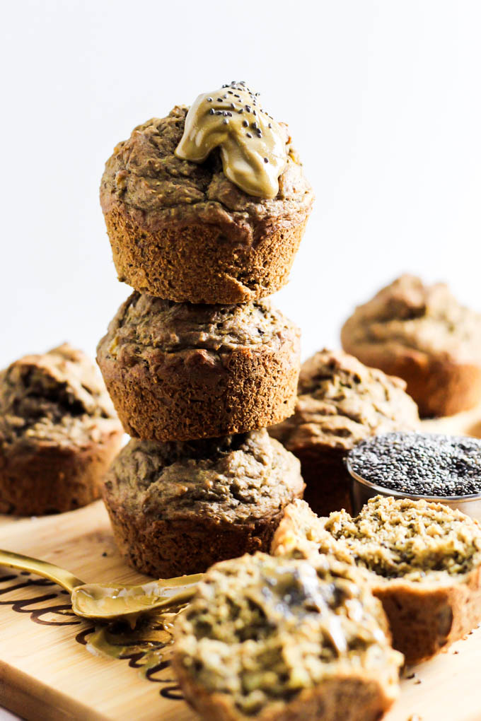a stack of three banana muffins on top of one another, topped off with almond butter