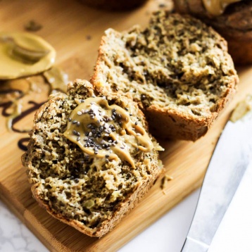 a chia banana muffin sliced in half and served with almond butter and chia seeds