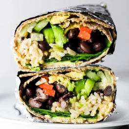 This Hummus Vegetable Wrap is a great on-the-go lunch option! Stuff it with all of your favorite vegetables, beans & creamy hummus. Vegan & gluten-free!
