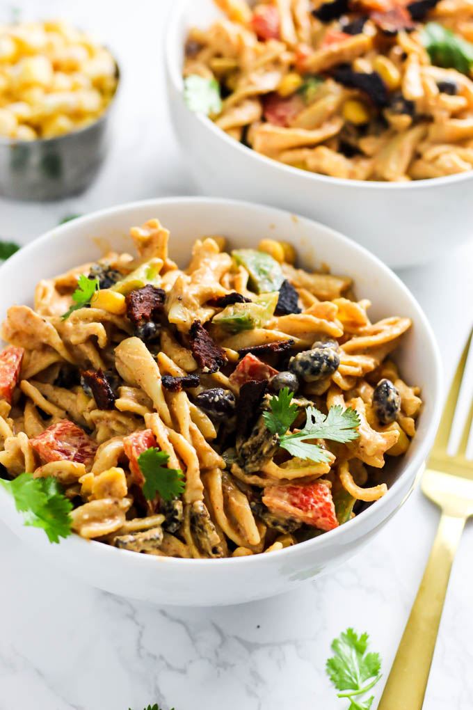 Two bowls of Mexican inspired pasta salad topped with fresh cilantro