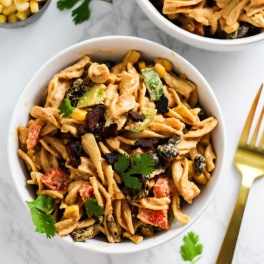 a bowl of mexican inspired pasta salad topped with cilantro
