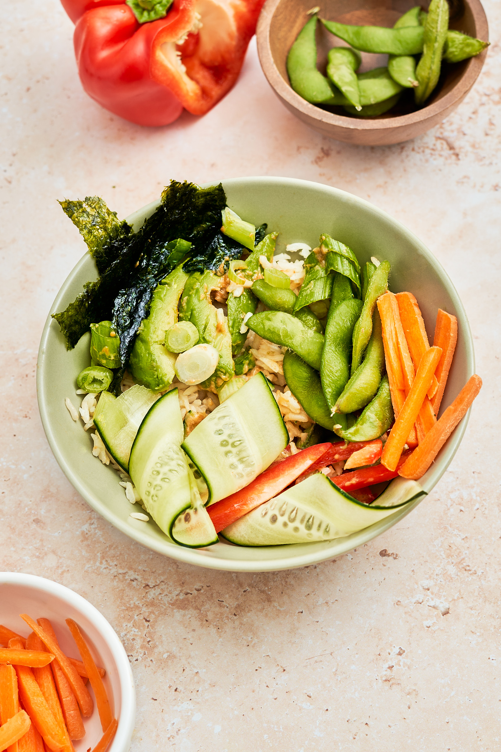 a vegan edamame bowl with rice, nori, veggies and avocado