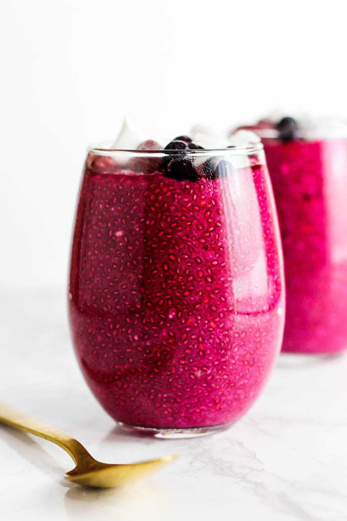 two glasses filled with a strawberry beet chia pudding