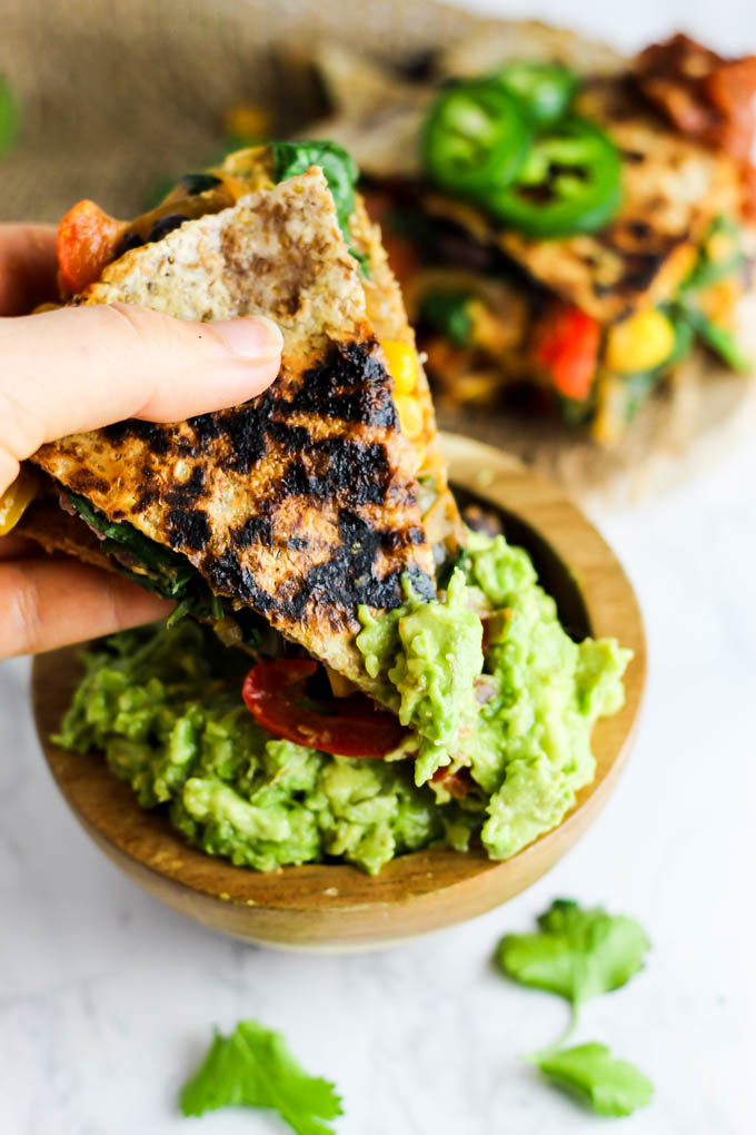 Enjoy this Vegan Quesadilla with Hummus & Vegetables for a healthy, flavorful meal or appetizer that is irresistible! Don't forget the guac. (gluten-free)
