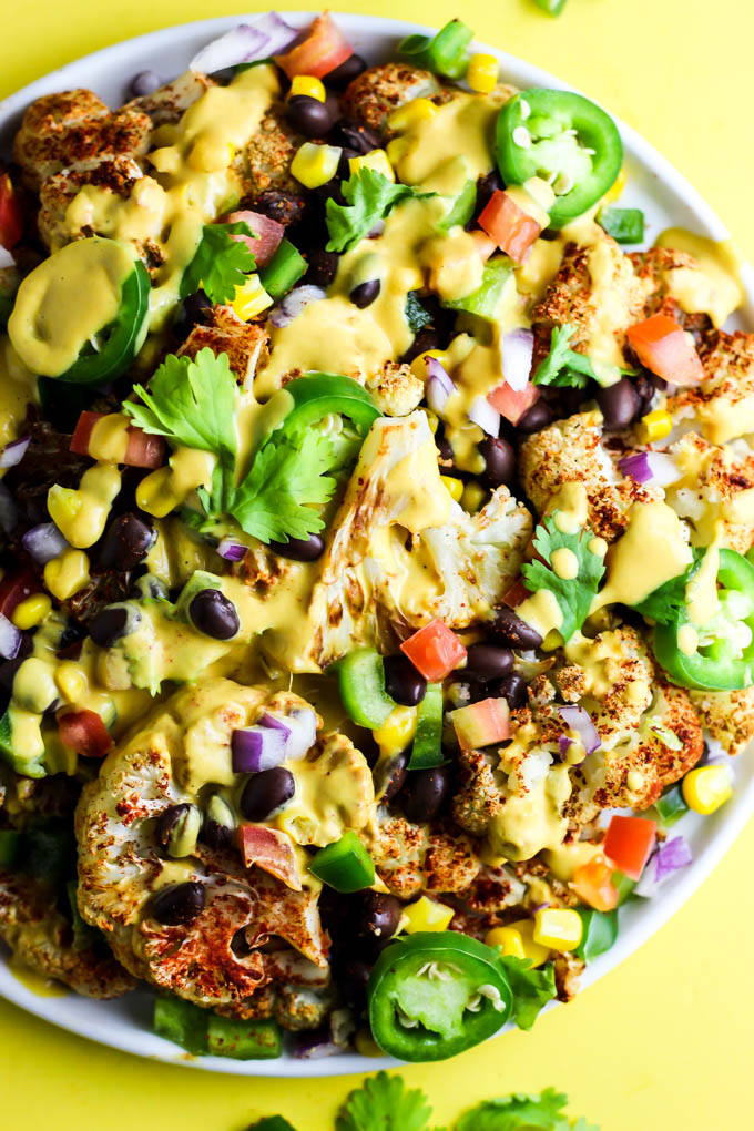 Not only are these vegan Loaded Cauliflower Nachos great for a party, but they're simple enough for a weeknight meal! Don't forget the creamy cashew queso.