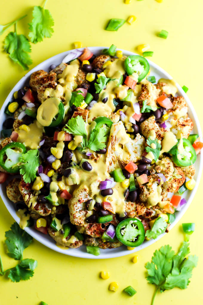 Not only are these vegan Loaded Cauliflower Nachos great for a party, but they're simple enough for a weeknight meal! Don't forget the creamy cashew queso.