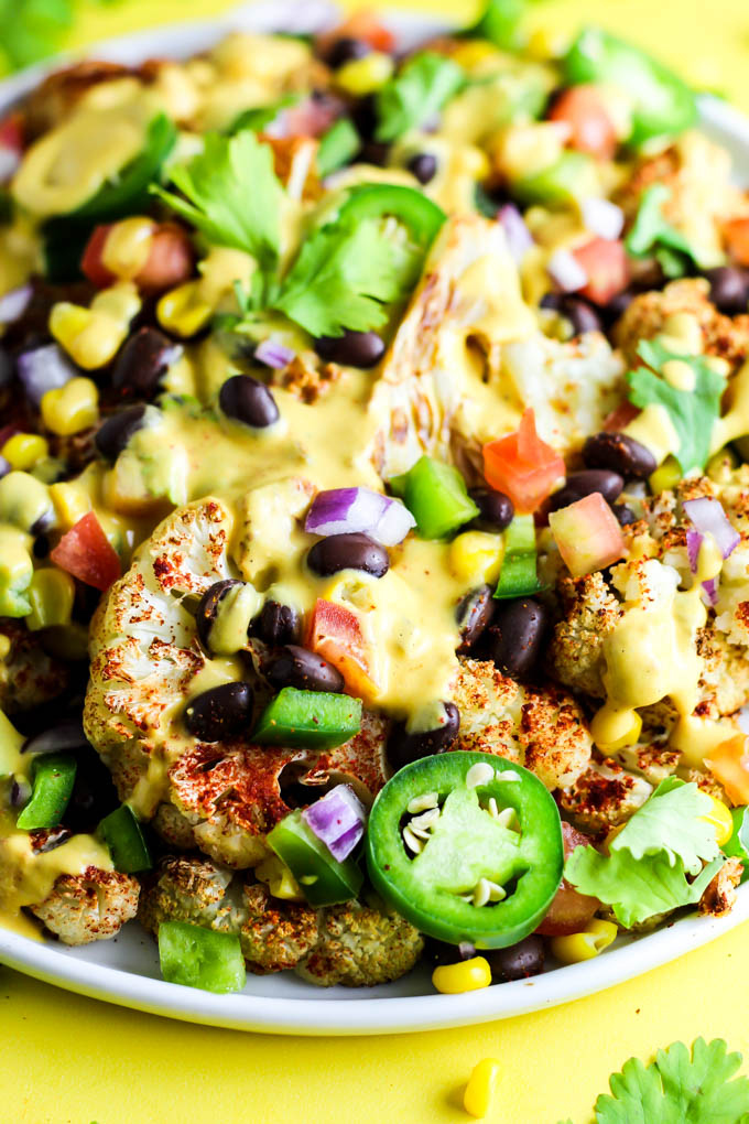 Not only are these vegan Loaded Cauliflower Nachos great for a party, but they're simple enough for a weeknight meal! Don't forget the creamy cashew queso.
