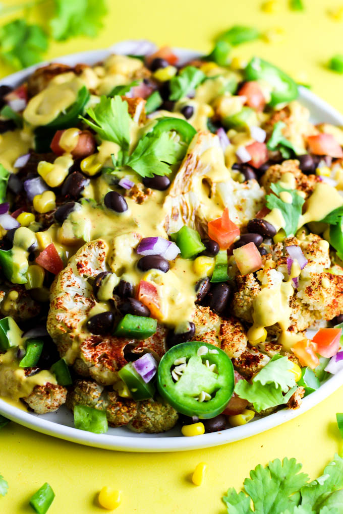 Not only are these vegan Loaded Cauliflower Nachos great for a party, but they're simple enough for a weeknight meal! Don't forget the creamy cashew queso.