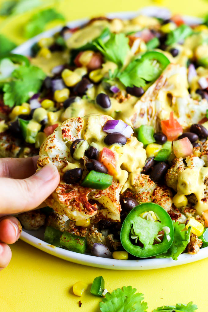 Not only are these vegan Loaded Cauliflower Nachos great for a party, but they're simple enough for a weeknight meal! Don't forget the creamy cashew queso.