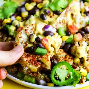 Not only are these vegan Loaded Cauliflower Nachos great for a party, but they're simple enough for a weeknight meal! Don't forget the creamy cashew queso.