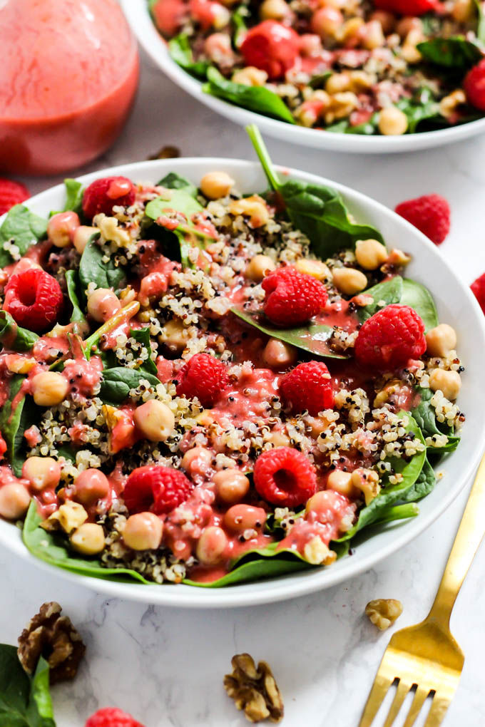 Enjoy the fresh flavors of the season with this fruity Quinoa Spinach Salad with Raspberry Vinaigrette! Serve it as a side or a meal. Vegan & gluten-free!