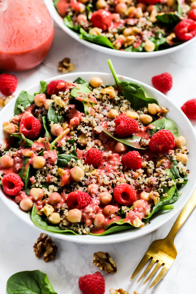 Enjoy the fresh flavors of the season with this fruity Quinoa Spinach Salad with Raspberry Vinaigrette! Serve it as a side or a meal. Vegan & gluten-free!