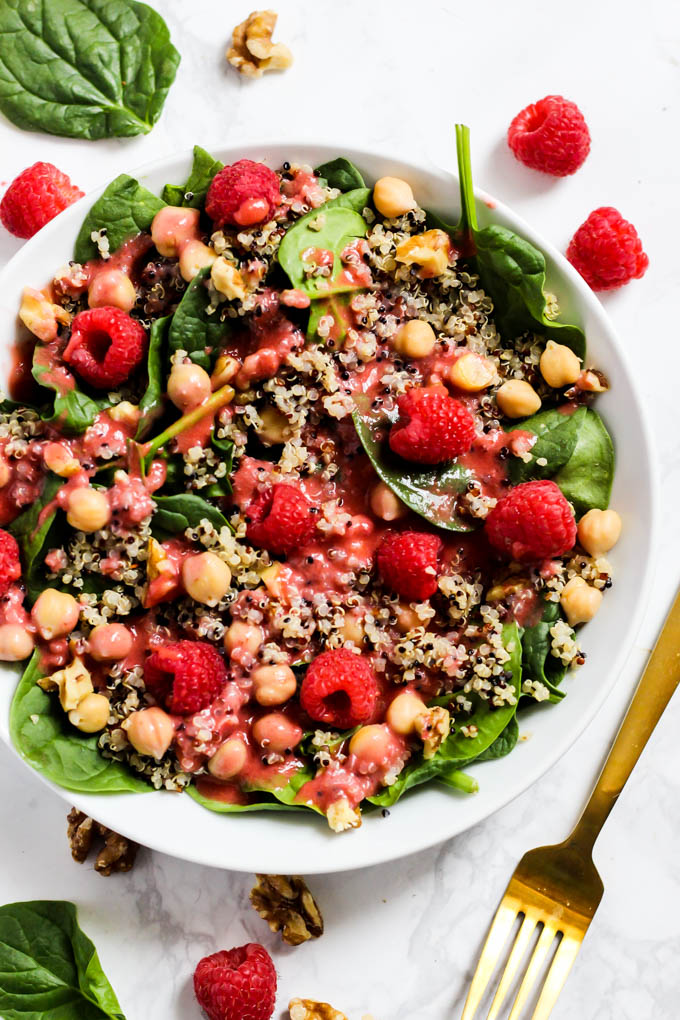 Enjoy the fresh flavors of the season with this fruity Quinoa Spinach Salad with Raspberry Vinaigrette! Serve it as a side or a meal. Vegan & gluten-free!