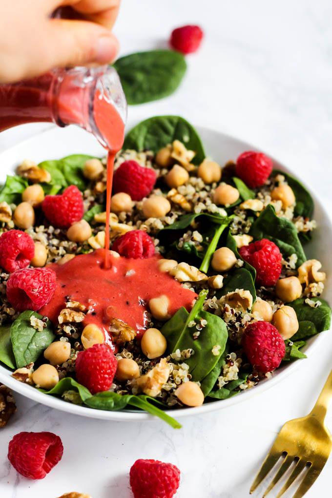 Enjoy the fresh flavors of the season with this fruity Quinoa Spinach Salad with Raspberry Vinaigrette! Serve it as a side or a meal. Vegan & gluten-free!