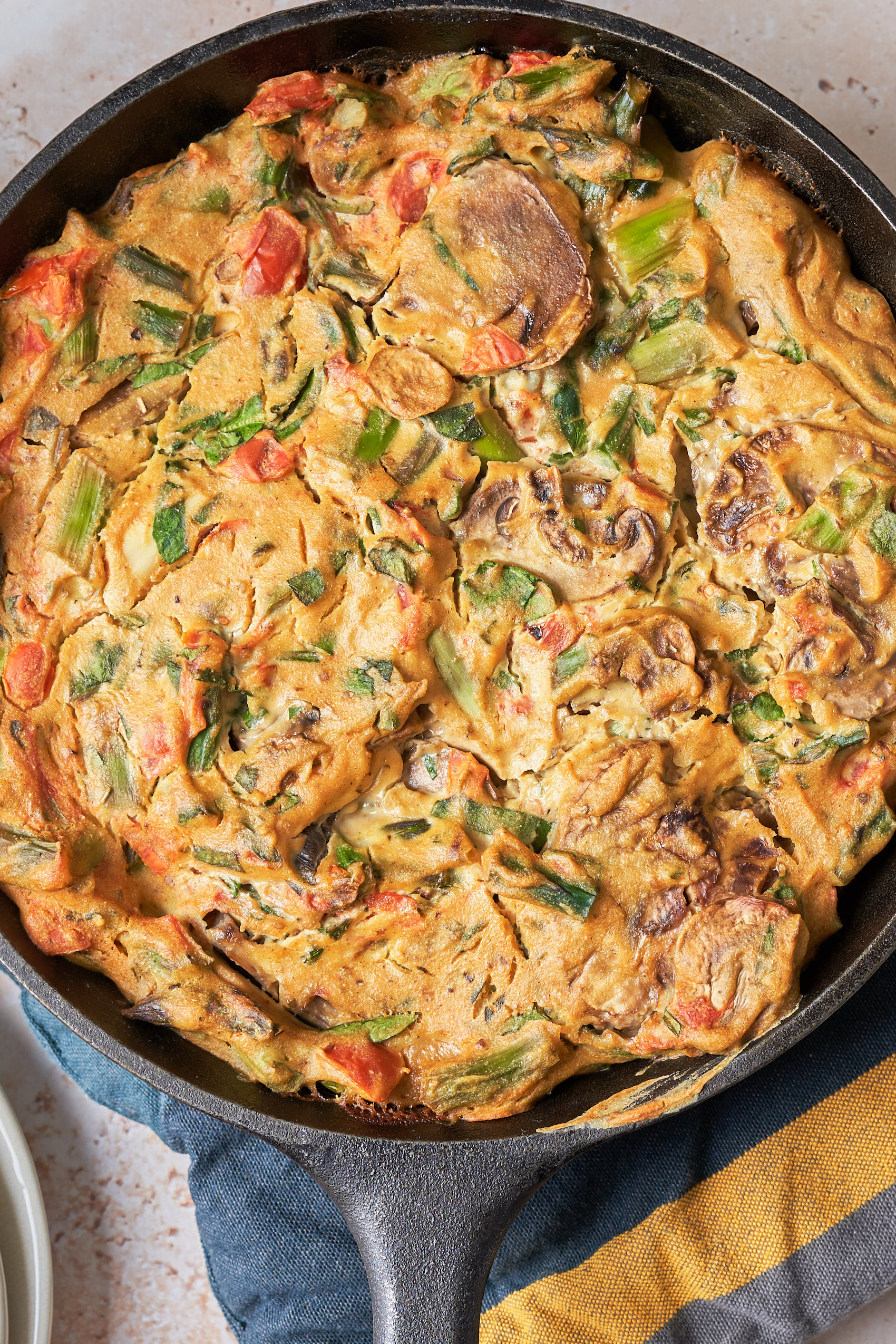 a closeup of a baked vegan vegetable quiche