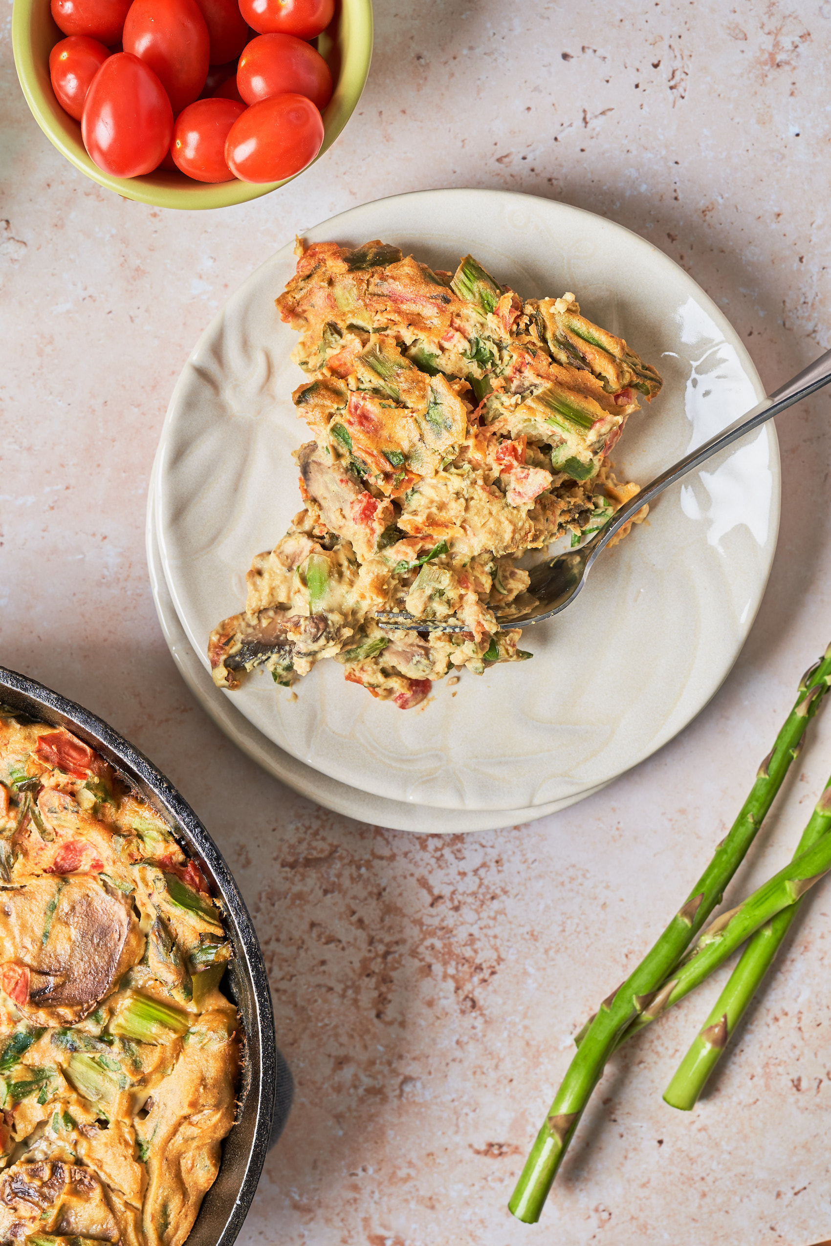 a slice of vegan quiche filled with mixed vegetables