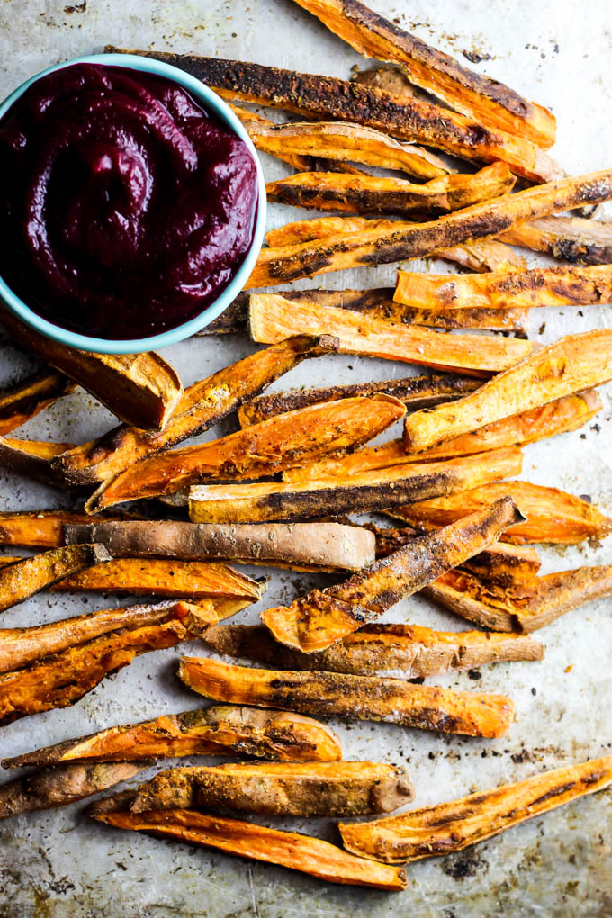 These extra Crispy Sweet Potato Fries dipped in tangy beet ketchup are the perfect addition to any dinner plate! A delicious vegan & gluten-free side dish.