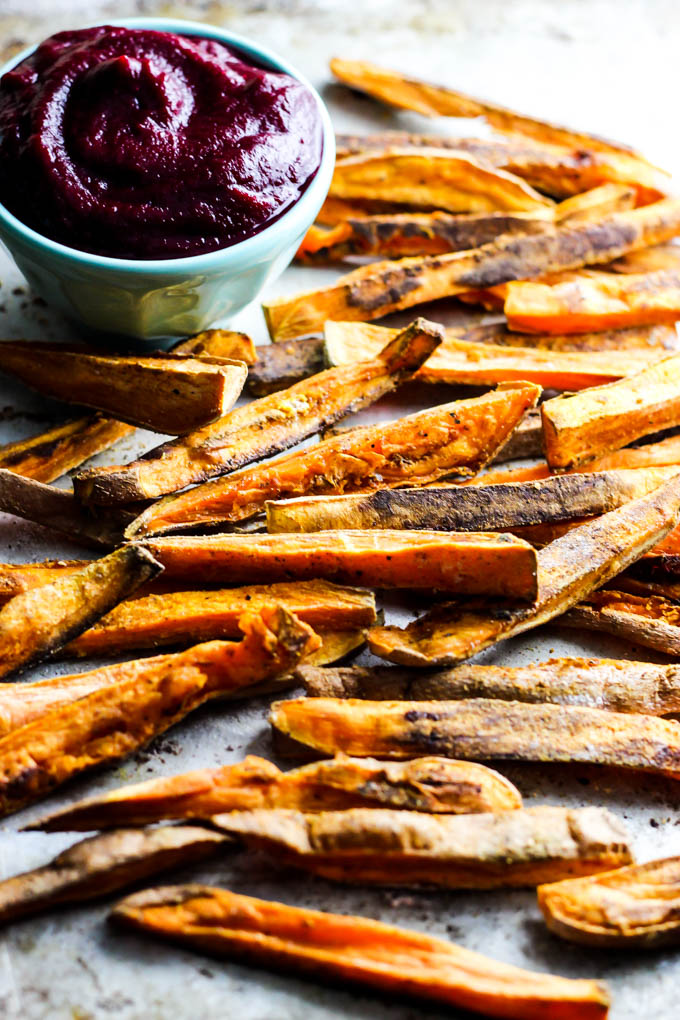 These extra Crispy Sweet Potato Fries dipped in tangy beet ketchup are the perfect addition to any dinner plate! A delicious vegan & gluten-free side dish.