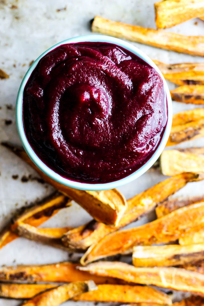 These extra Crispy Sweet Potato Fries dipped in tangy beet ketchup are the perfect addition to any dinner plate! A delicious vegan & gluten-free side dish.
