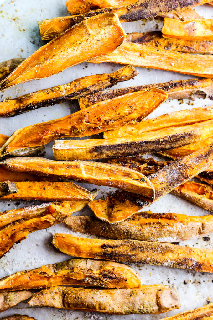 These extra Crispy Sweet Potato Fries dipped in tangy beet ketchup are the perfect addition to any dinner plate! A delicious vegan & gluten-free side dish.