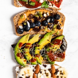 slices of whole grain toast topped with various vegan toppings