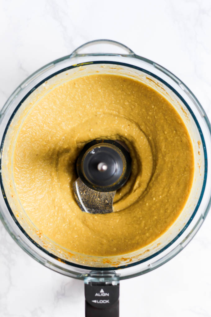 A smoothie bowl being blended in a food processor
