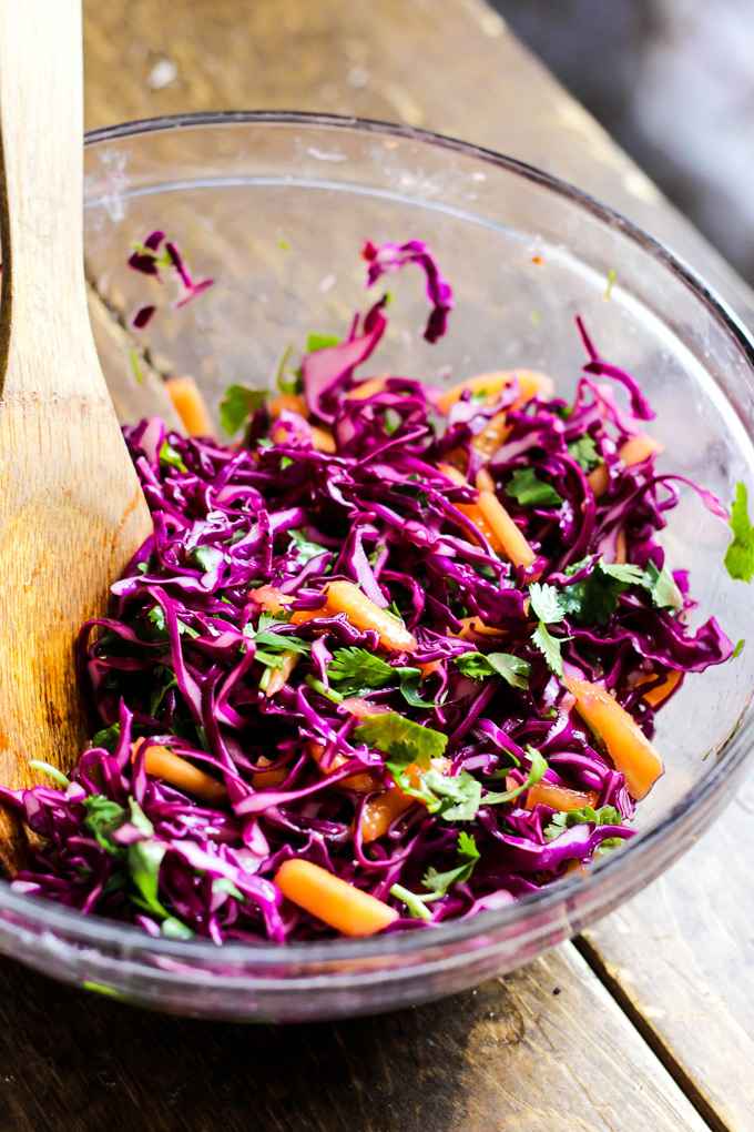 These vegan Asian Veggie Burgers are full of flavor & plant protein! Perfect for weekend grilling, topped with Mango Cabbage slaw and spicy Sriracha sauce.