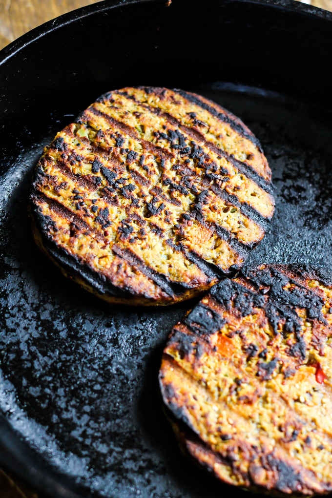 These vegan Asian Veggie Burgers are full of flavor & plant protein! Perfect for weekend grilling, topped with Mango Cabbage slaw and spicy Sriracha sauce.