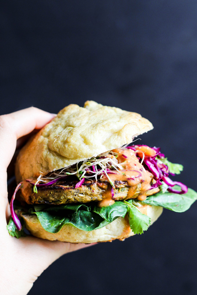 These vegan Asian Veggie Burgers are full of flavor & plant protein! Perfect for weekend grilling, topped with Mango Cabbage slaw and spicy Sriracha sauce.