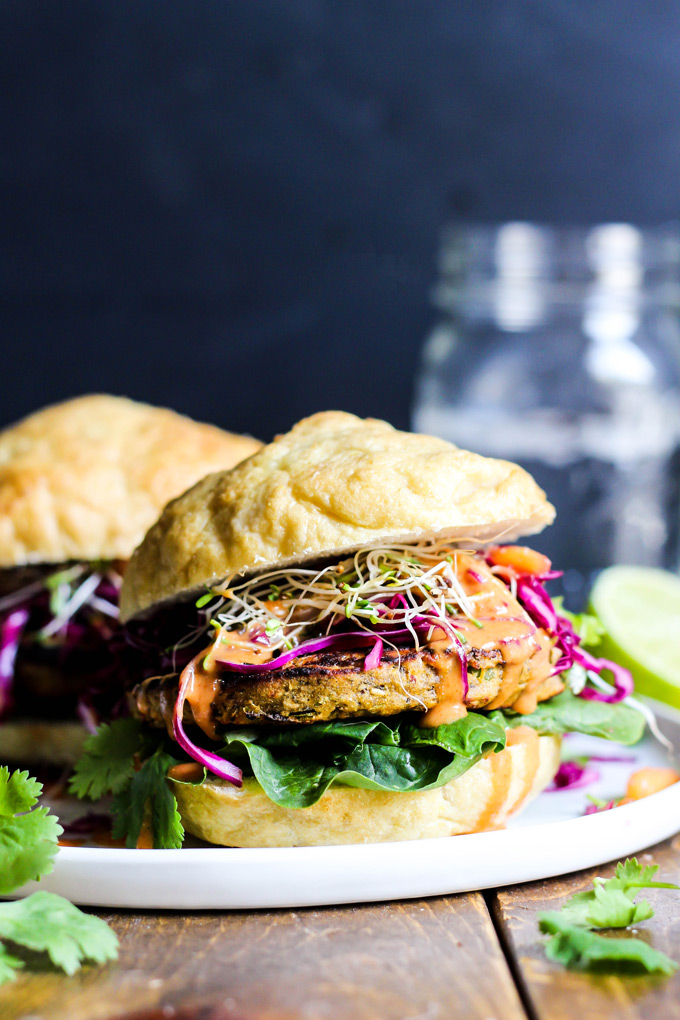 These vegan Asian Veggie Burgers are full of flavor & plant protein! Perfect for weekend grilling, topped with Mango Cabbage slaw and spicy Sriracha sauce.