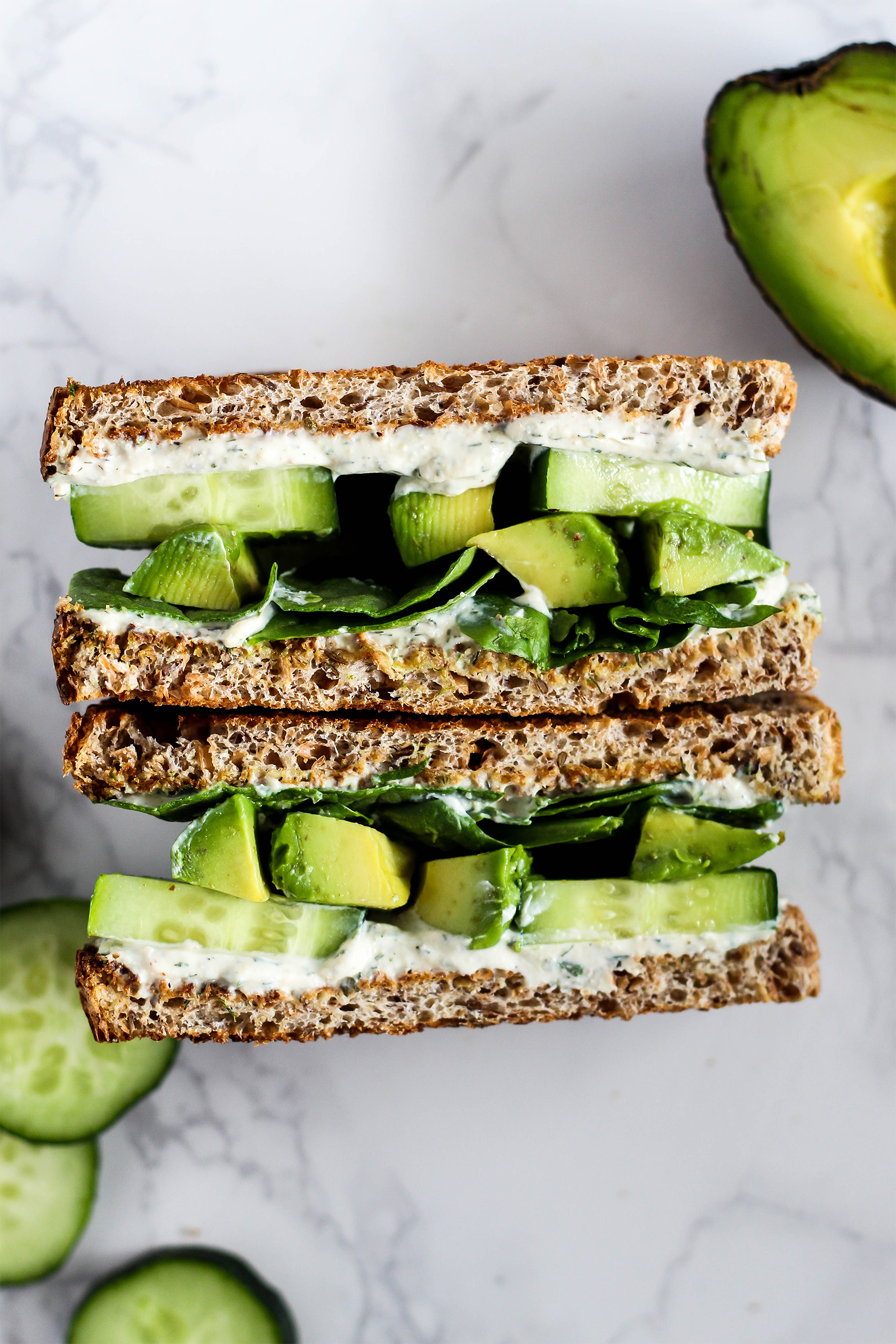 two halves of a vegan cream cheese, avocado and cucumber sandwich