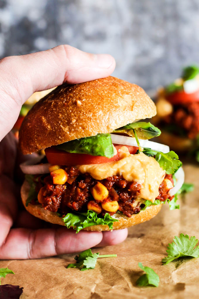 a hand holding a vegan sloppy joe slider