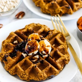 two waffles each topped with sliced bananas, chopped pecans and molasses