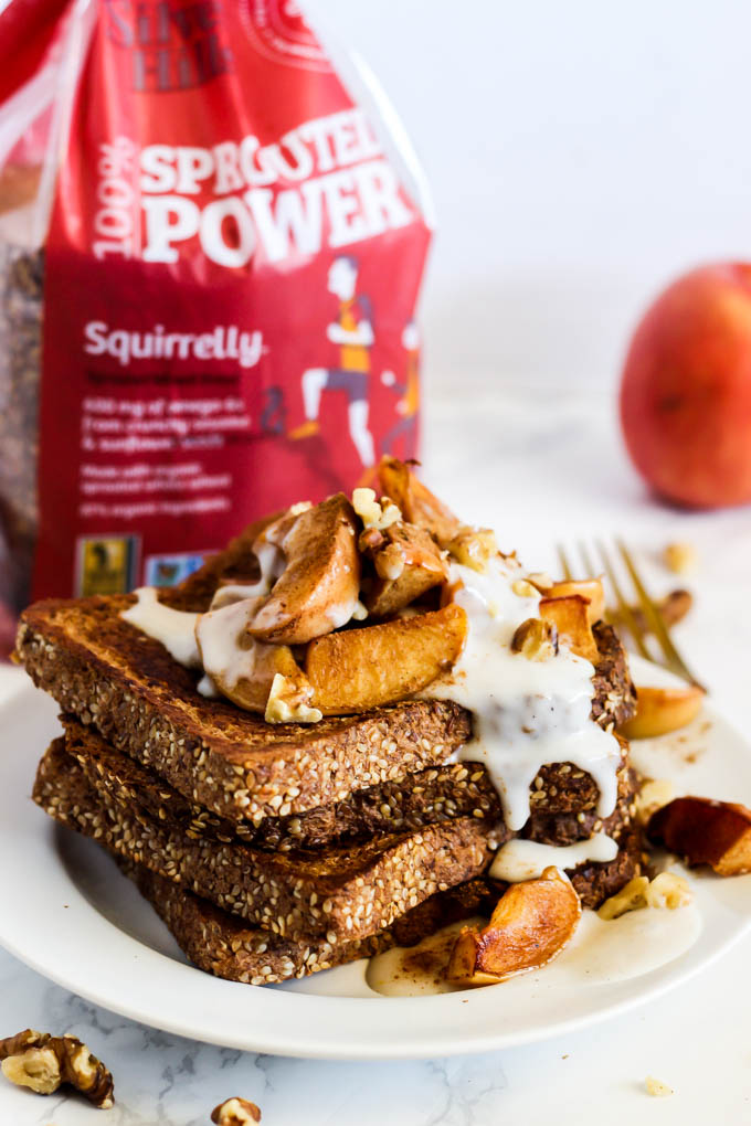 a stack of french toast topped with apples and vegan yogurt