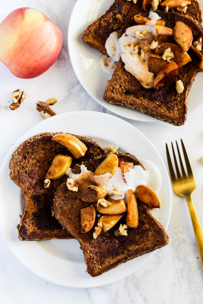 two plates of french toast topped with cooked apples