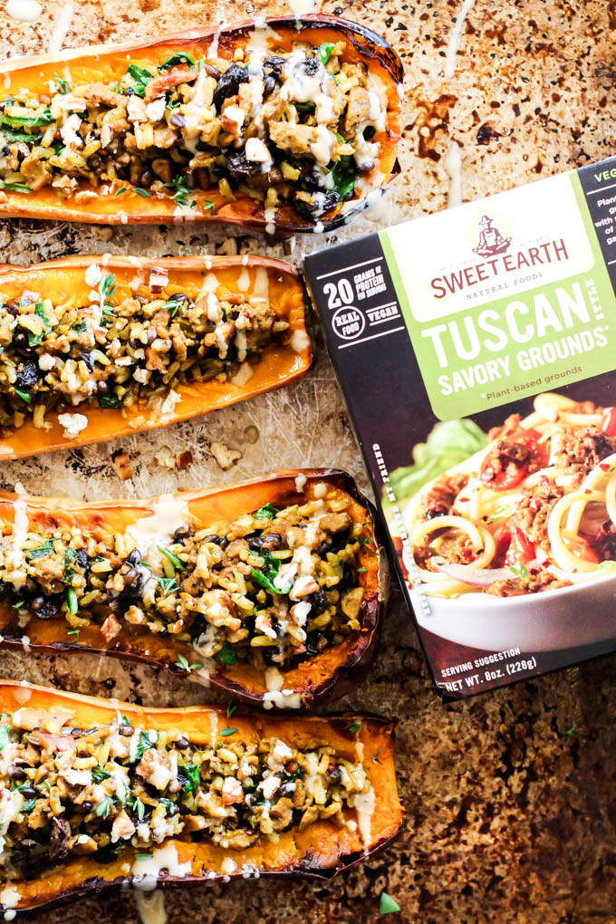 a sheet tray of stuffed butternut squash next to a box of vegan grounds