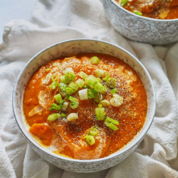 a bowl of sweet potato coconut soup topped with green onion