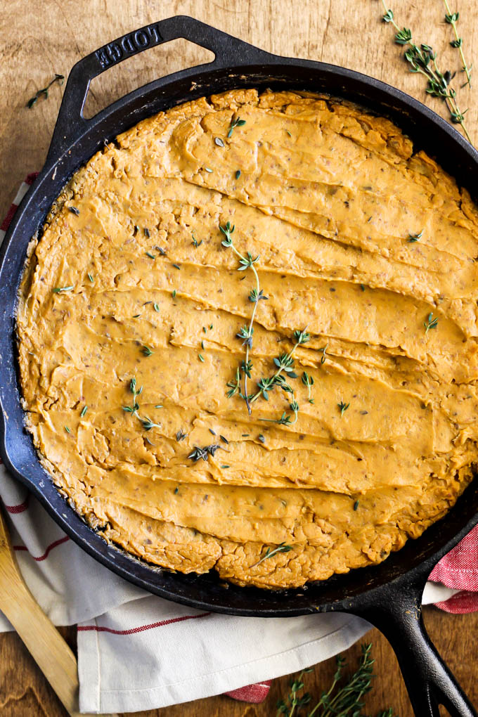 a cast iron skillet with a sweet potato shepherd's pie