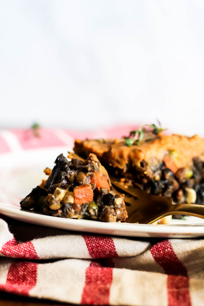 a fork taking a bite of a vegan shepherd's pie