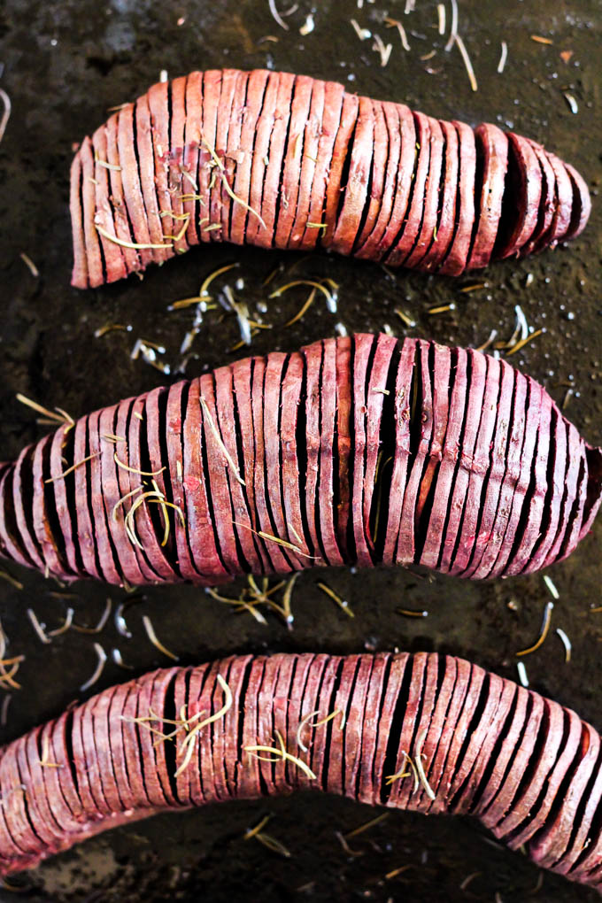 a sheet tray of hasselback style sweet potatoes