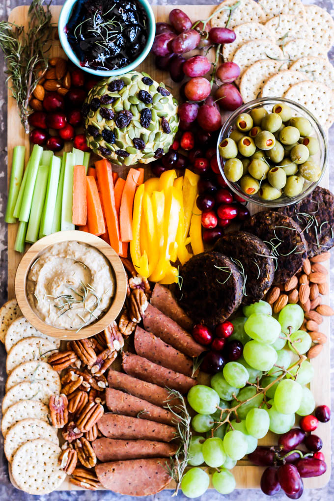 Serve this epic Vegan Charcuterie Board at your next party as a fun appetizer! Loaded with veggie meats, dairy-free cheese, fruit and vegetables.