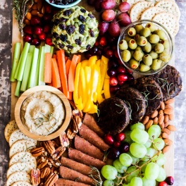 Serve this epic Vegan Charcuterie Board at your next party as a fun appetizer! Loaded with veggie meats, dairy-free cheese, fruit and vegetables.