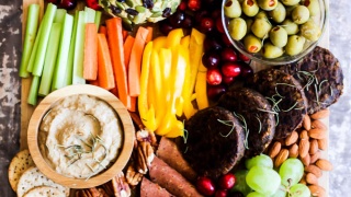 Serve this epic Vegan Charcuterie Board at your next party as a fun appetizer! Loaded with veggie meats, dairy-free cheese, fruit and vegetables.